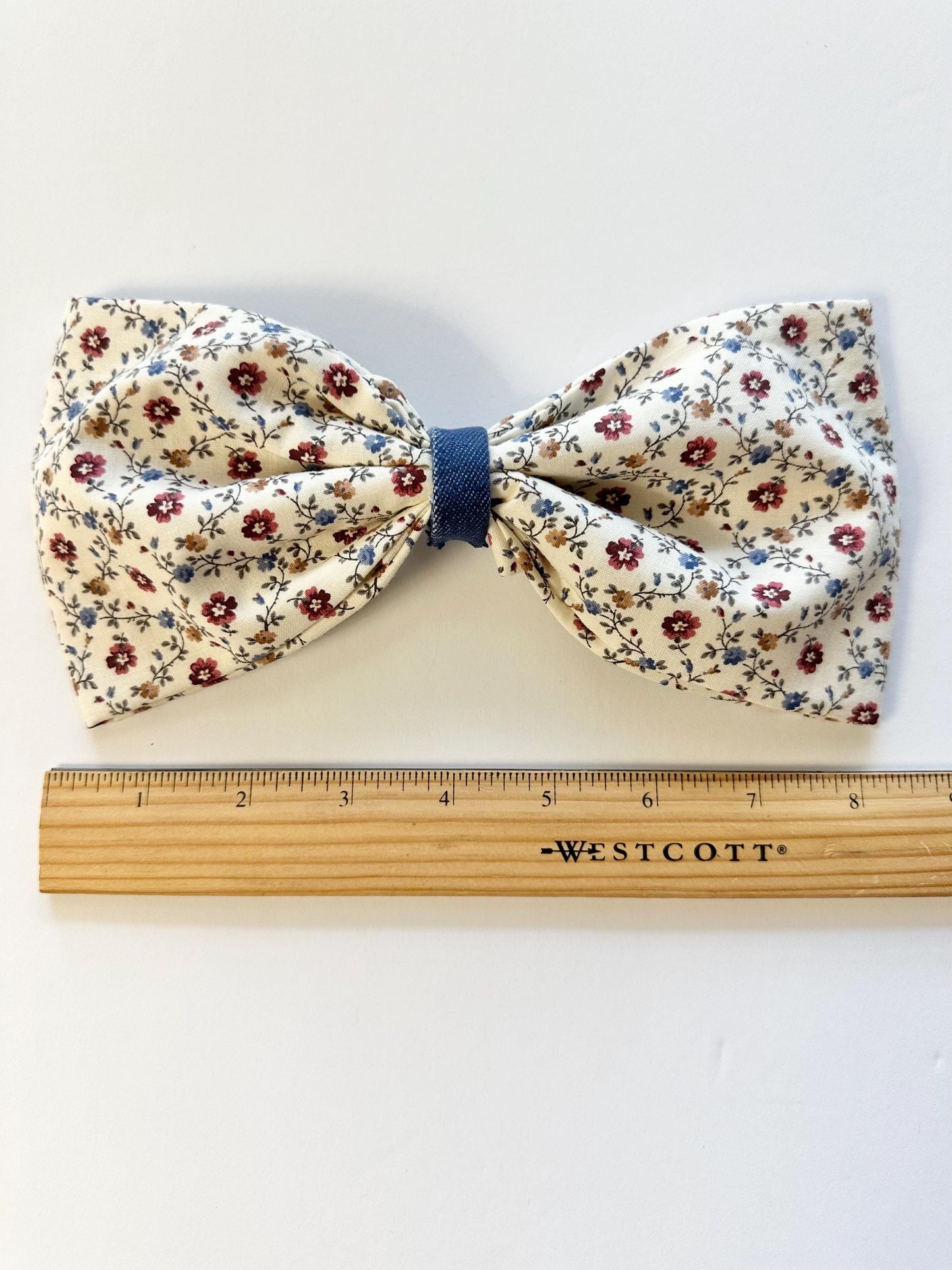8 inch wide floral print hair bow with alligator clip attachment on the back.